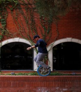 Man on unicycle as metaphor for how holistic health in Manchester can help restore equilibrium