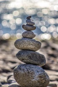 Pebbles balanced on top of each other as a metaphor for what holistic health in Manchester can offer