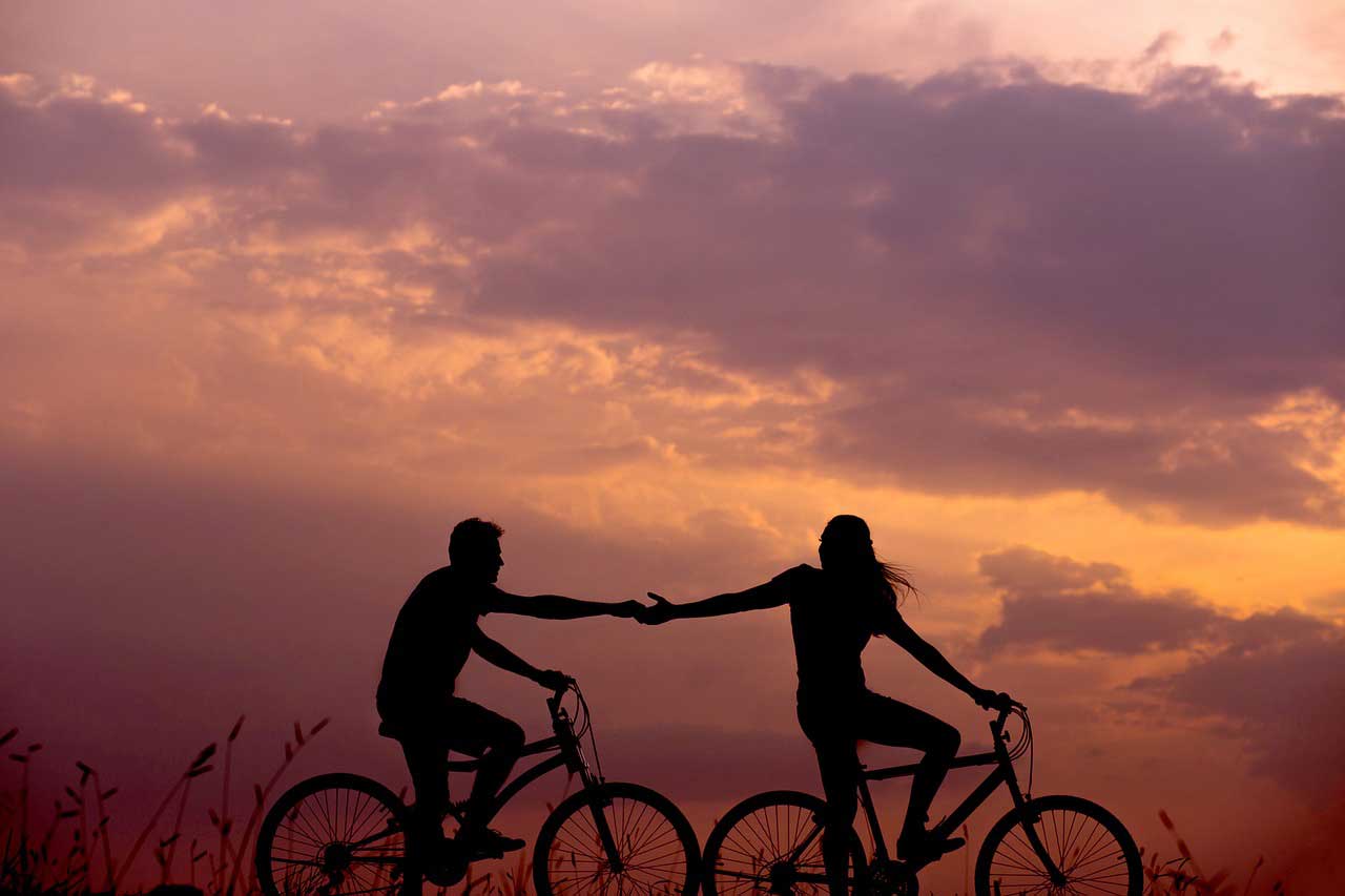 Get the Love you want- couple cycling at sunset