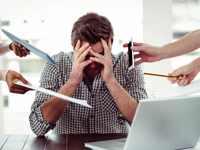 CBT Therapy for stress with a man being handed more work by many people